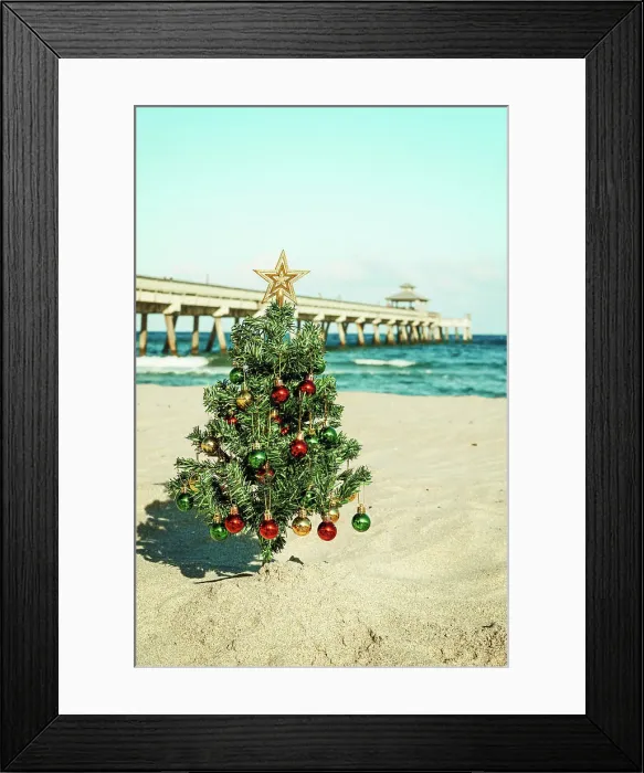 Framed Print : Christmas tree on the beach with pier in background Framed Print : Christmas tree on the beach with pier in background