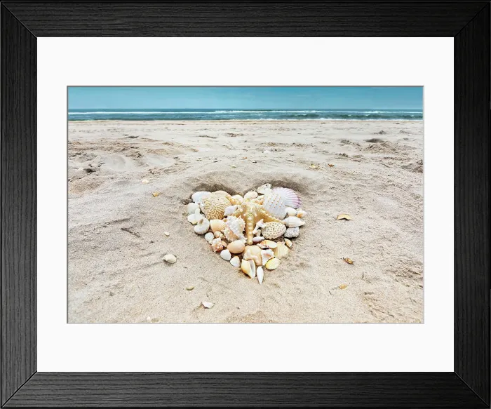 Framed Print : Seashells arranged in heart shape on beach