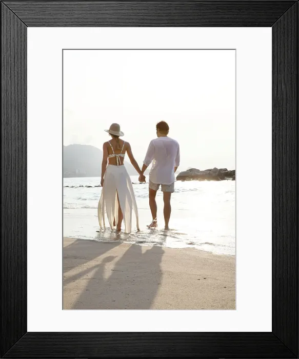 Framed Print : Couple walking along beach Framed Print : Couple walking along beach