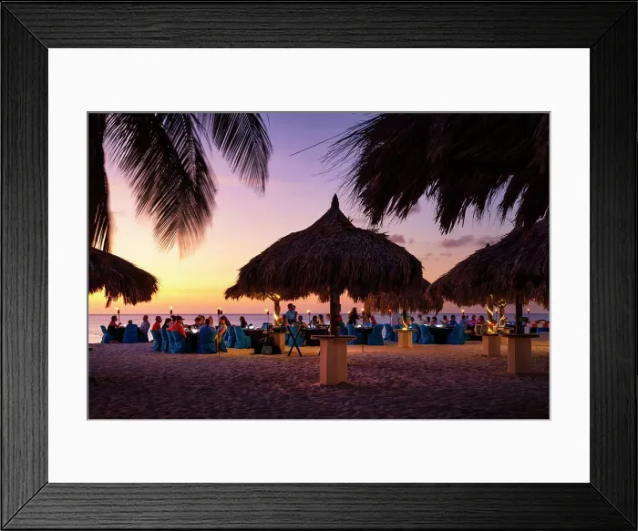 Framed Print : Aruba, Eagle beach scene at dusk with people dining by the sea Framed Print : Aruba, Eagle beach scene at dusk with people dining by the sea