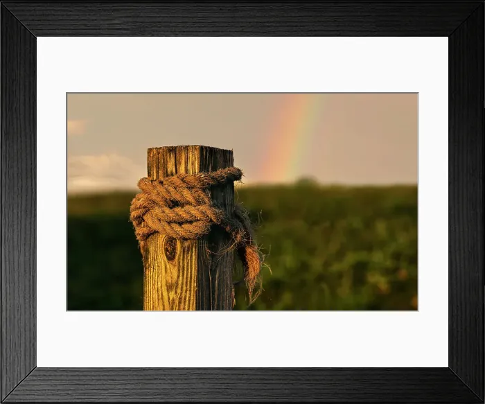 Framed Print : Wooden beam with rope tied around it, rainbow in background Framed Print : Wooden beam with rope tied around it, rainbow in background