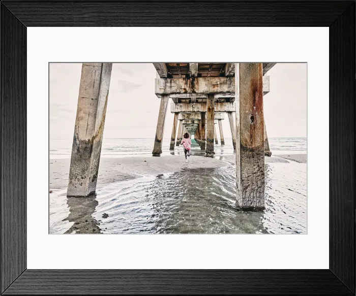 Framed Print : Florida, South Florida, woman running under the Juno beach pier Framed Print : Florida, South Florida, woman running under the Juno beach pier