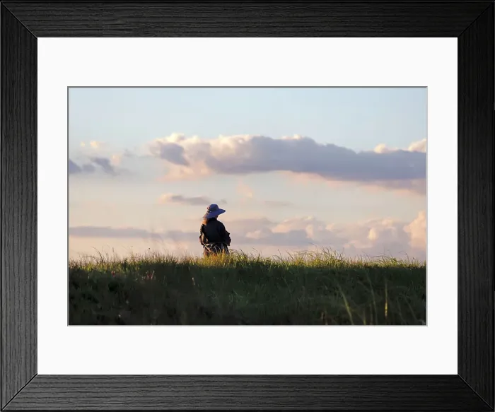 Framed Print : Pensive woman on an open field Framed Print : Pensive woman on an open field