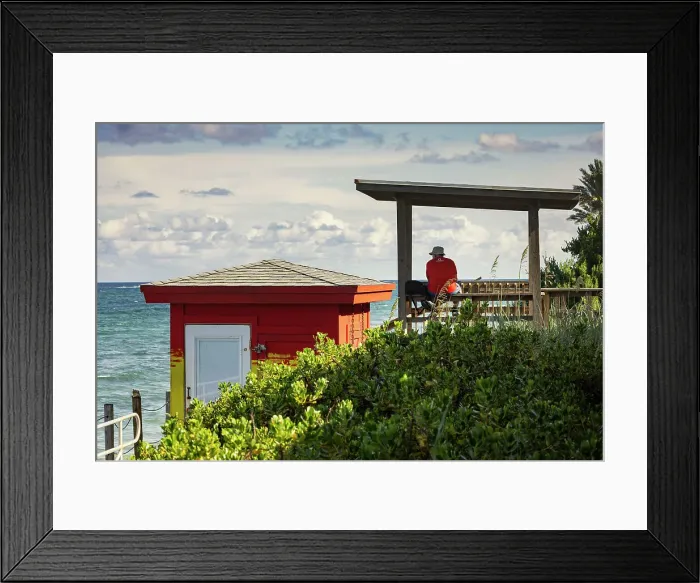 Framed Print : Florida, Lantana, beach with man sitting near colorful lifeguard station Framed Print : Florida, Lantana, beach with man sitting near colorful lifeguard station
