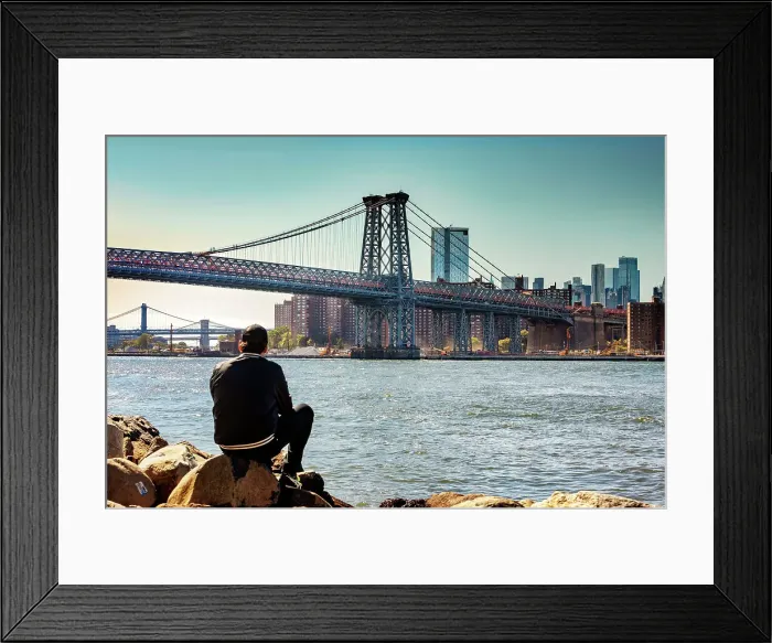 Framed Print : New York City, NY, Williamsburg Bridge with skyline from Grand Ferry Park, man on rock Framed Print : New York City, NY, Williamsburg Bridge with skyline from Grand Ferry Park, man on rock