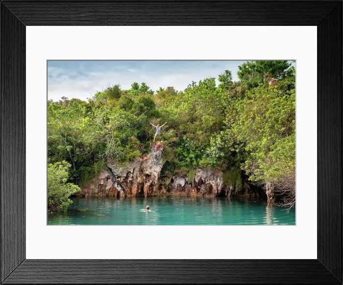 Framed Print : Bermuda, Blue Hole Park, Woman jumping into aquamarine swimming hole