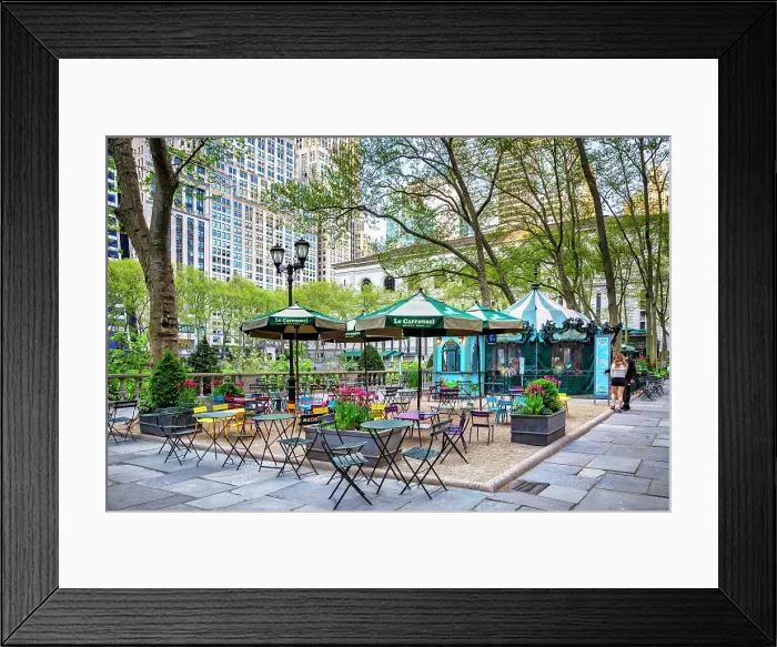 Framed Print : New York City, Manhattan, Bryant Park, sitting area with tables and carousel Framed Print : New York City, Manhattan, Bryant Park, sitting area with tables and carousel