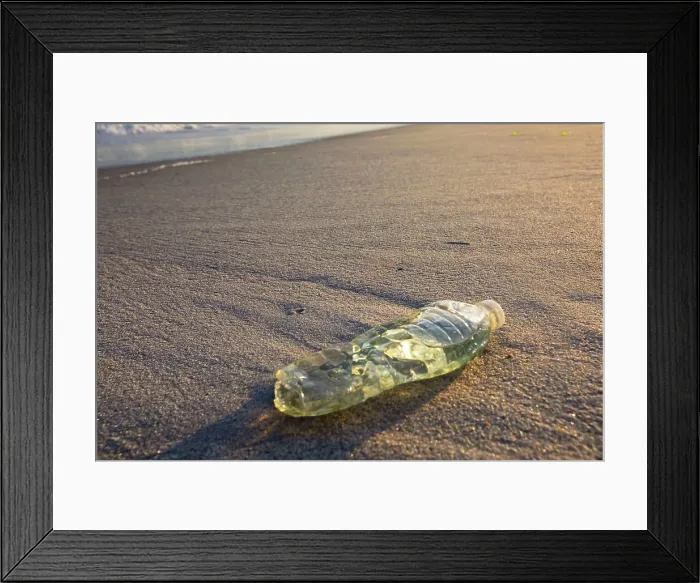 Framed Print : Plastic bottle on a beach