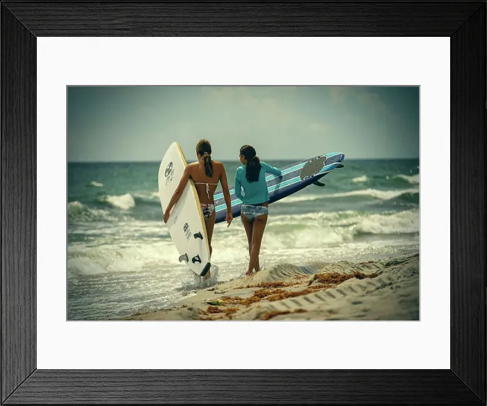 Framed Print : 2 female surfers at the beach Framed Print : 2 female surfers at the beach