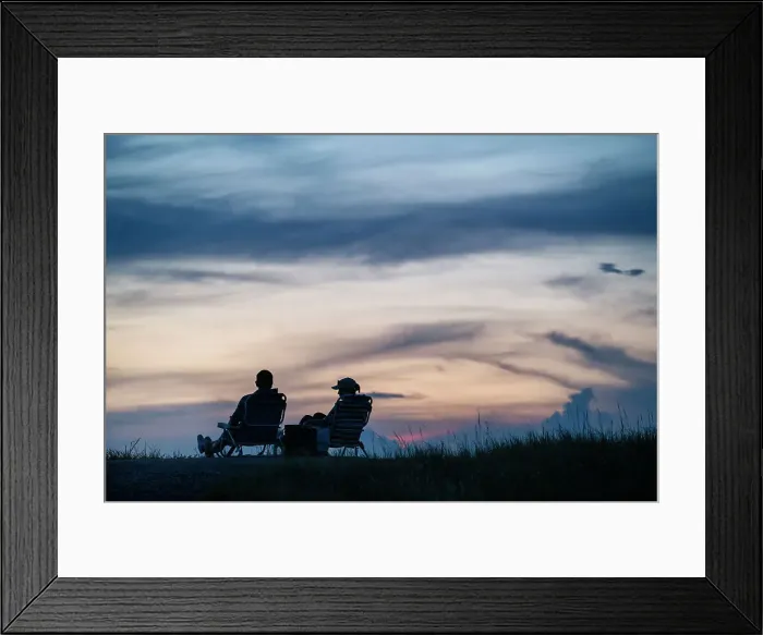 Framed Print : Silhouette of couple sitting at a park at sunset Framed Print : Silhouette of couple sitting at a park at sunset