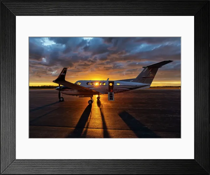 Framed Print : Airplane on tarmac at sunset
