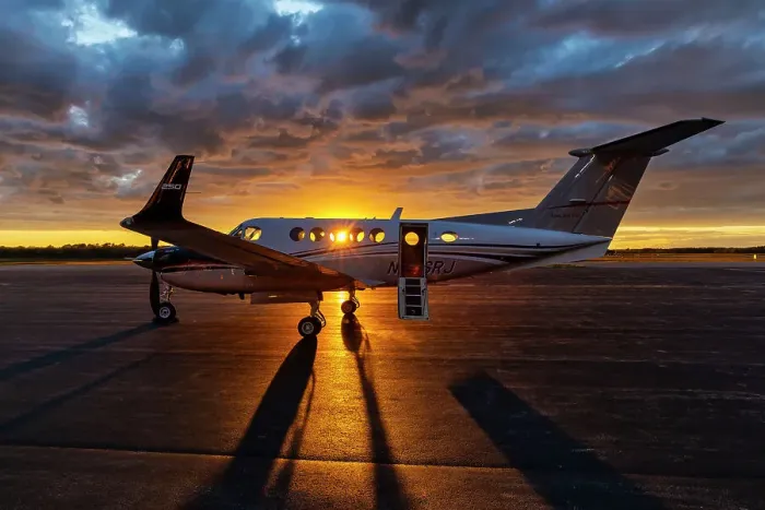 Framed Print : Airplane on tarmac at sunset