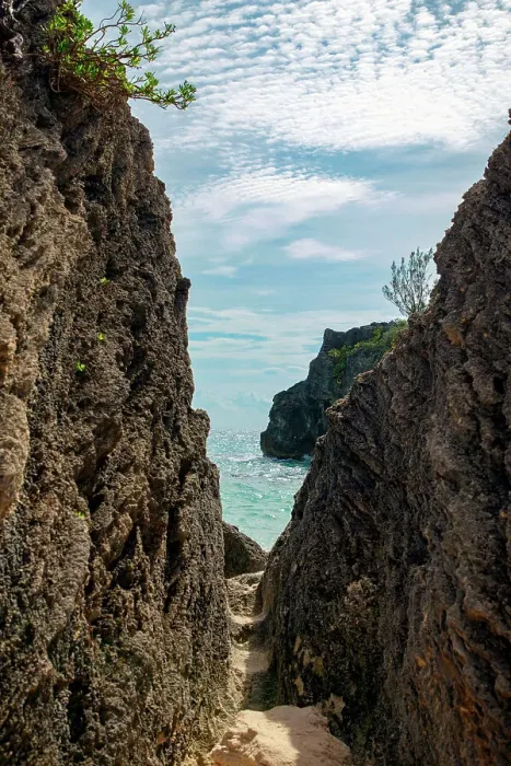 Framed Print : Bermuda, View of beach through narrow gap between rocks Framed Print : Bermuda, View of beach through narrow gap between rocks