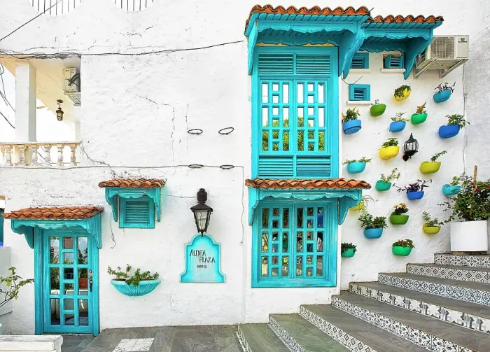 Framed Print : Colombia, Colorful Facade with Plant Pots on a wall in La Aldea (Colombian Santorini)