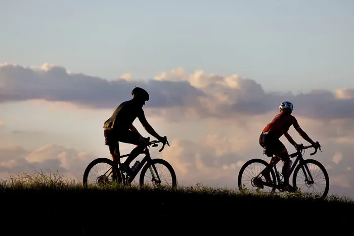 Framed Print : Two cyclists silhouetted at sunset