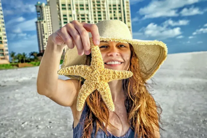 Framed Print : Florida, Marco Island, Beach, woman holding starfish Framed Print : Florida, Marco Island, Beach, woman holding starfish