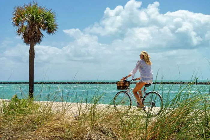 Framed Print : Florida, Miami Beach, South Pointe Park, Woman biking on the beach Framed Print : Florida, Miami Beach, South Pointe Park, Woman biking on the beach