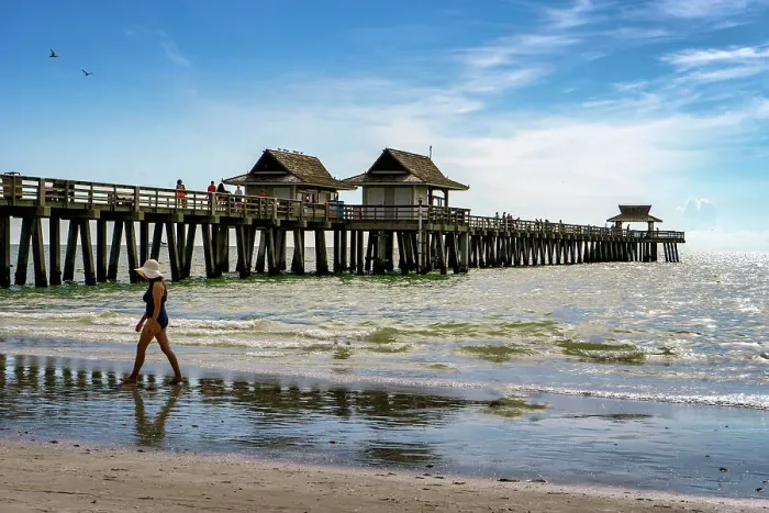 Framed Print : Florida, Naples, Fishing Pier, Woman strolling on the beach