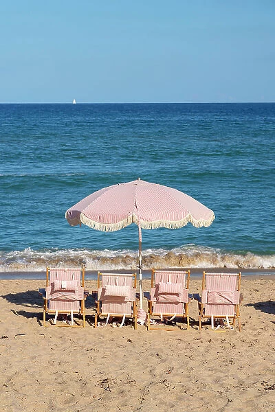 Florida, Palm Beach, colorful beach umbrella and chairs
