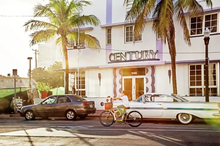 Framed Print : Florida, South Beach, person riding bicycle in front of Century Hotel Framed Print : Florida, South Beach, person riding bicycle in front of Century Hotel