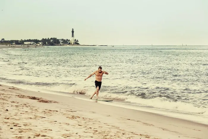 Framed Print : Florida, South Florida, Surfer with Hillsboro Inlet Lighthouse in background Framed Print : Florida, South Florida, Surfer with Hillsboro Inlet Lighthouse in background