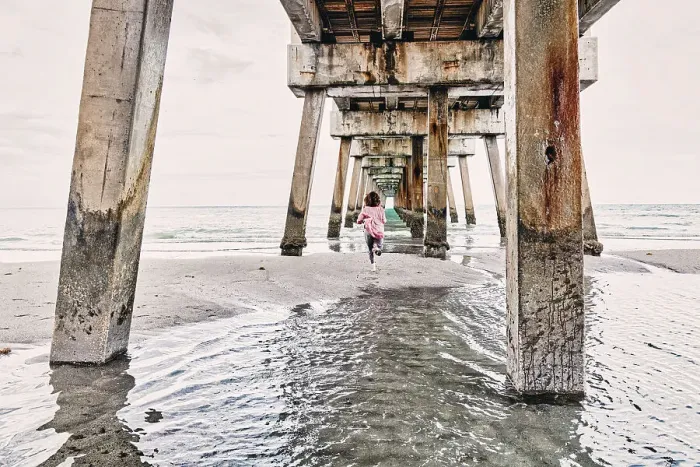 Framed Print : Florida, South Florida, woman running under the Juno beach pier Framed Print : Florida, South Florida, woman running under the Juno beach pier