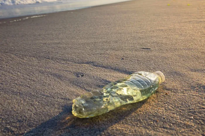 Framed Print : Plastic bottle on a beach