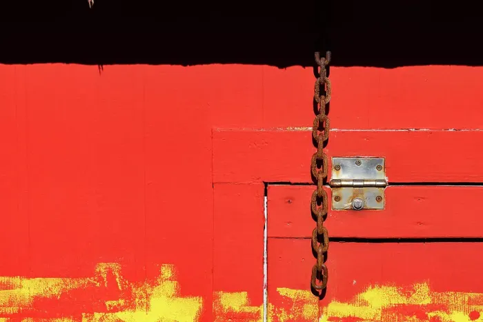 Framed Print : Red wooden structure with door hinge and chain Framed Print : Red wooden structure with door hinge and chain