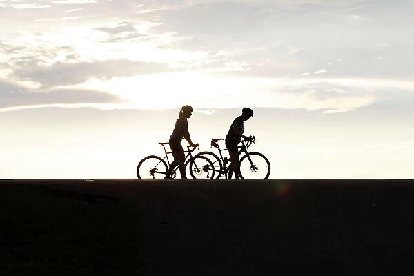 Silhouette of two female cyclists