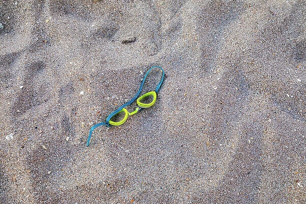 Swimming goggles on sand