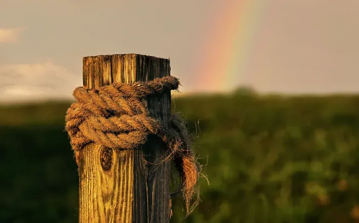 Framed Print : Wooden beam with rope tied around it, rainbow in background Framed Print : Wooden beam with rope tied around it, rainbow in background