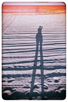 Images Dated 22nd May 2023: Abstract of figure taking a photo on the beach