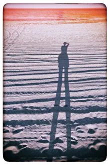 East Coast Prints: Abstract of figure taking a photo on the beach
