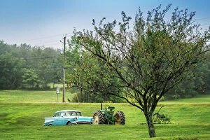 Images Dated 6th September 2017: Americana scene, sky blue Chevrolet car next to a John Deer tractor