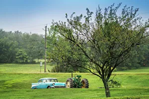 Lawn Prints: Americana scene, sky blue Chevrolet car next to a John Deer tractor