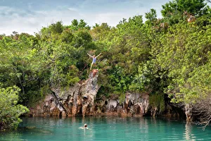 Island Prints: Bermuda, Blue Hole Park, Woman jumping into aquamarine swimming hole