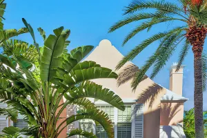 Bermuda, Rosewood Bermuda Hotel grounds and palm trees in front of building facade