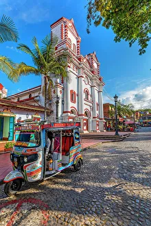 Colombia, Antioquia, Guatape, Nuestra Senora del Carmen church with Mototaxi