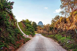 Images Dated 6th December 2023: Colombia, Antioquia, Rural road with view of Penon de Guatape Rock