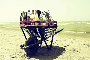 Coast Prints: Colombia, Cartagena, Mobile bar in wheelbarrow on beach