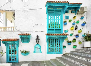 Colombia, Colorful Facade with Plant Pots on a wall in La Aldea (Colombian Santorini)