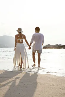 Love Prints: Couple walking along beach