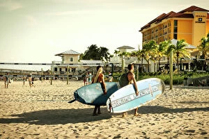 Trending: Florida, Deerfield Beach, two surfers walking on beach