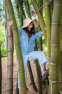 Florida, Fort Myers, Edison and Ford Winter Estates, woman climbing bamboo tree