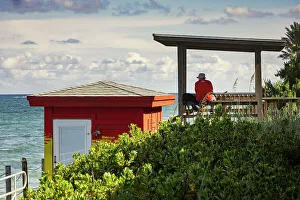 Atlantic Prints: Florida, Lantana, beach with man sitting near colorful lifeguard station