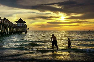 Sunsetting Prints: Florida, Naples, Fishing Pier, Playing on the beach
