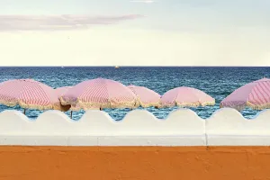 Florida, Palm Beach, colorful beach umbrellas facing the ocean