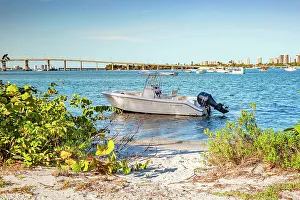 Florida, Palm Beach County, Peanut Island, Motor boat near beach with Blue Heron Bridge