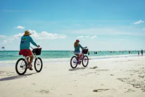 Coast Prints: Florida, Sarasota, Siesta Key, Couple Bike riding on beach