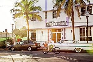 Images Dated 8th December 2023: Florida, South Beach, person riding bicycle in front of Century Hotel